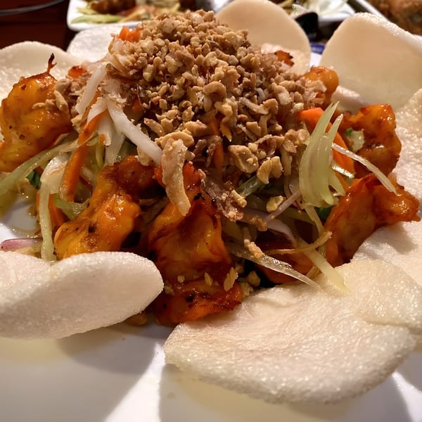 Belmarasia's Asian-fusion dish with orange chicken, shredded vegetables, peanuts, and crispy rice crackers.
