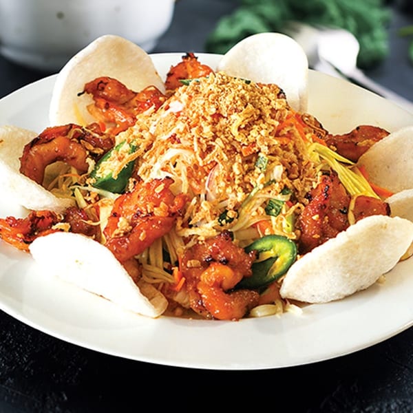 Belmarasia's Asian-fusion shrimp dish with noodles, vegetables, crispy toppings, and shrimp crackers.